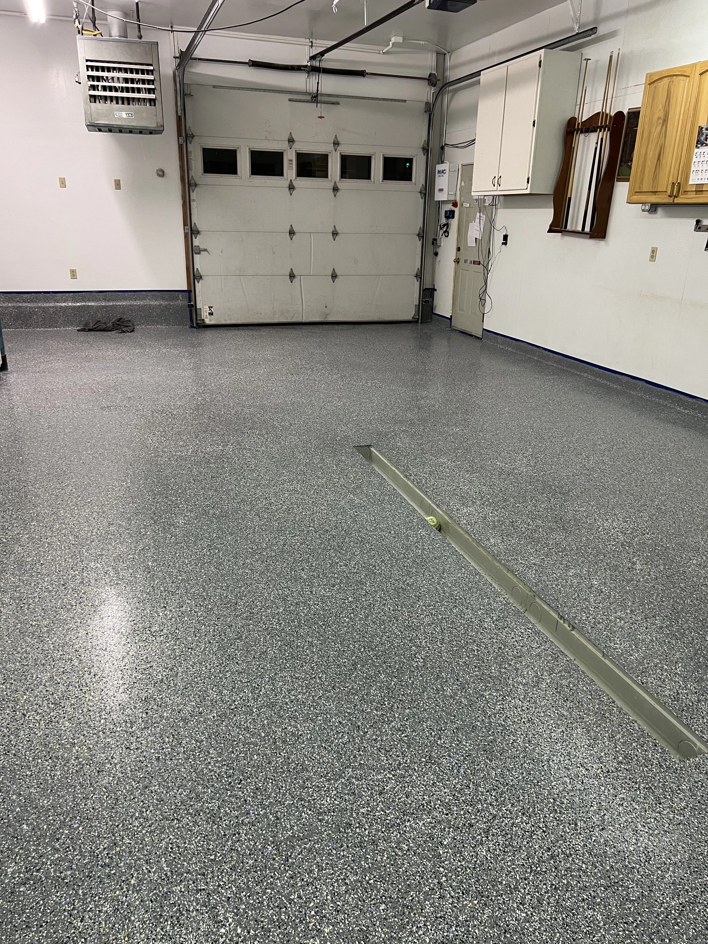 Gray flake epoxy garage floor with door and drain channel